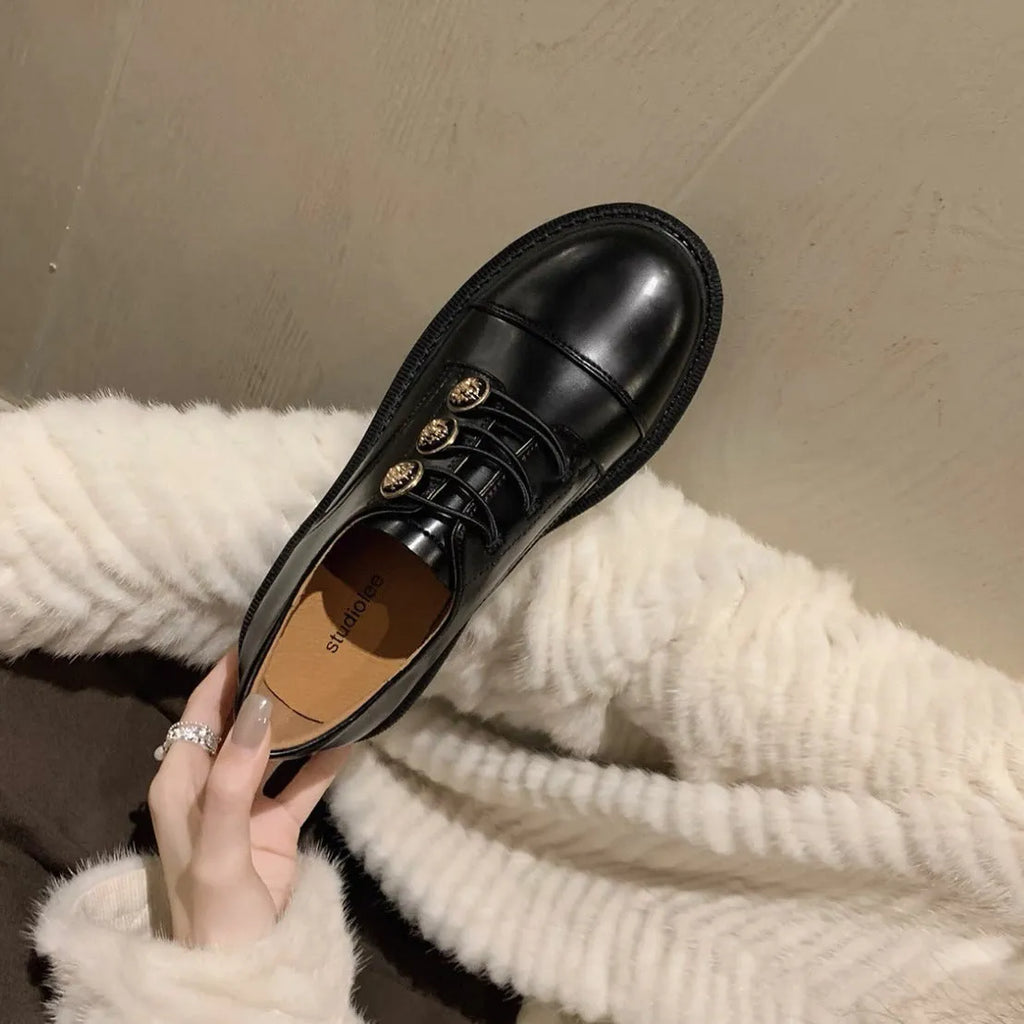 Glossy black block heel pumps with round toe and cowhide upper