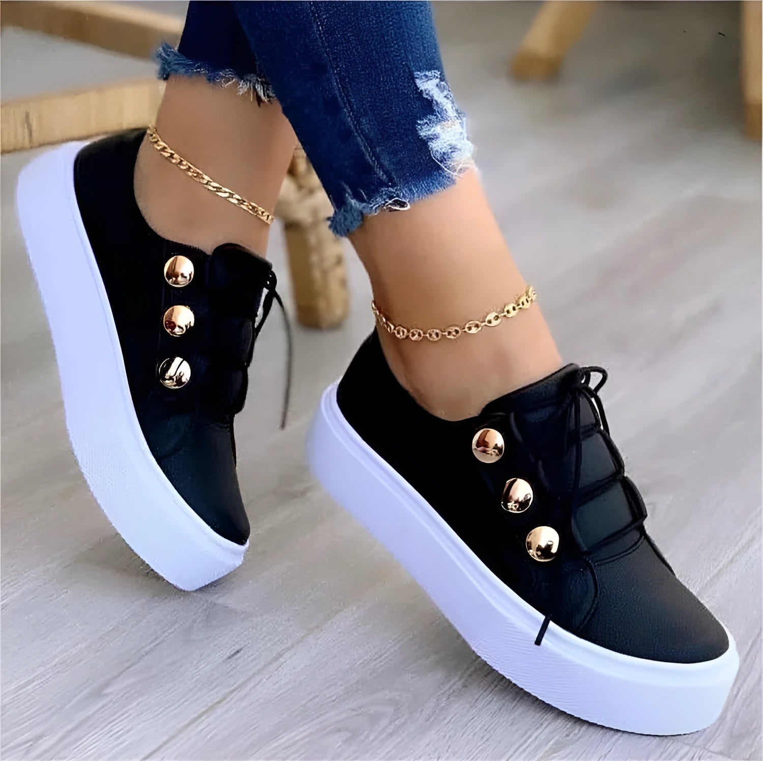 Women's white lace-up casual sneaker flats with silver rivet details on the round toe and low-top design.