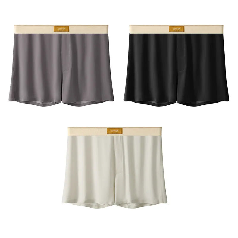 Pack of three pairs of men's solid colour ice silk underwear on a white background.