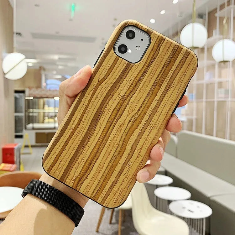 A slim wooden back cover case for an iPhone, showing the natural grain of rosewood or bamboo.