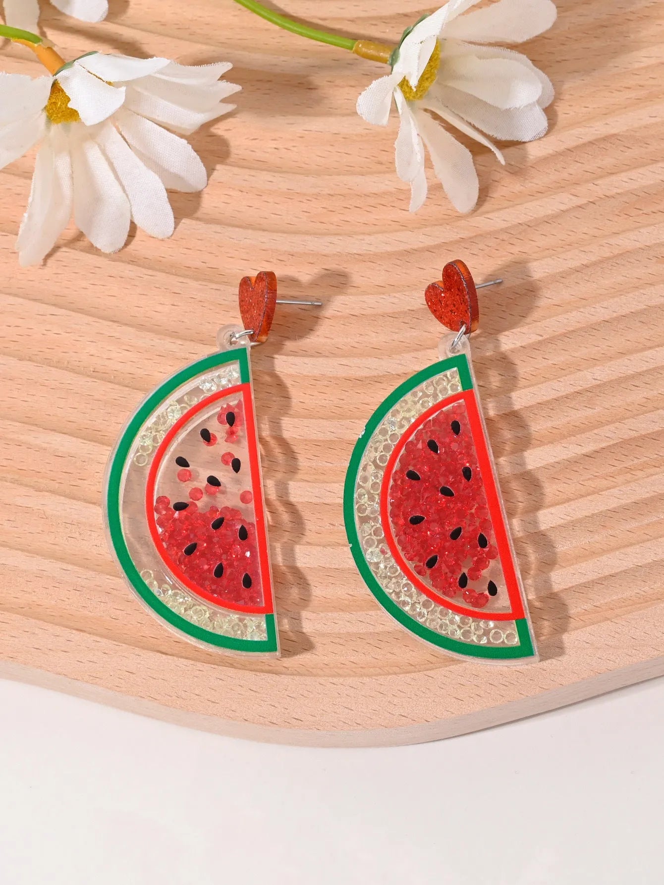Colourful acrylic novelty earrings shaped like fruits and desserts including cherry, strawberry, and ice cream.