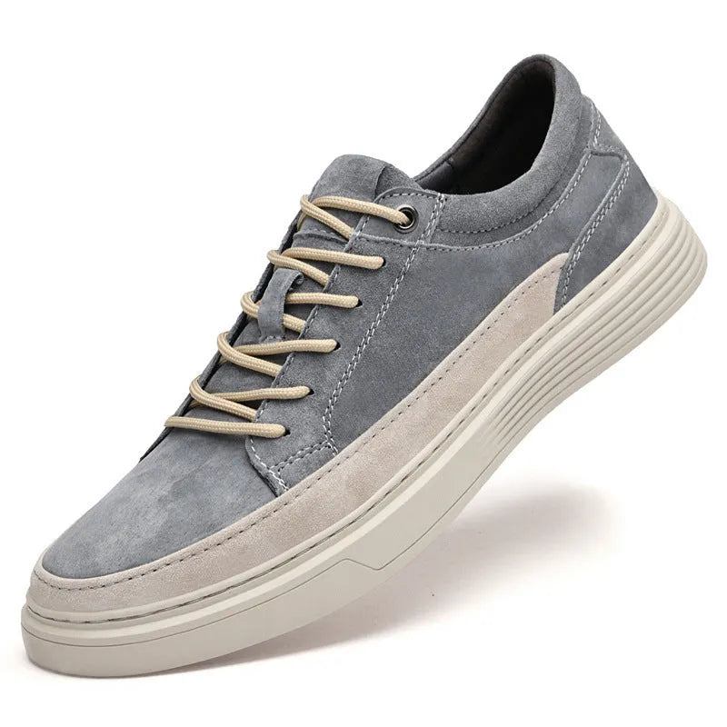Men's grey low-top pigskin leather skate shoes with flat rubber sole and lace-up front.