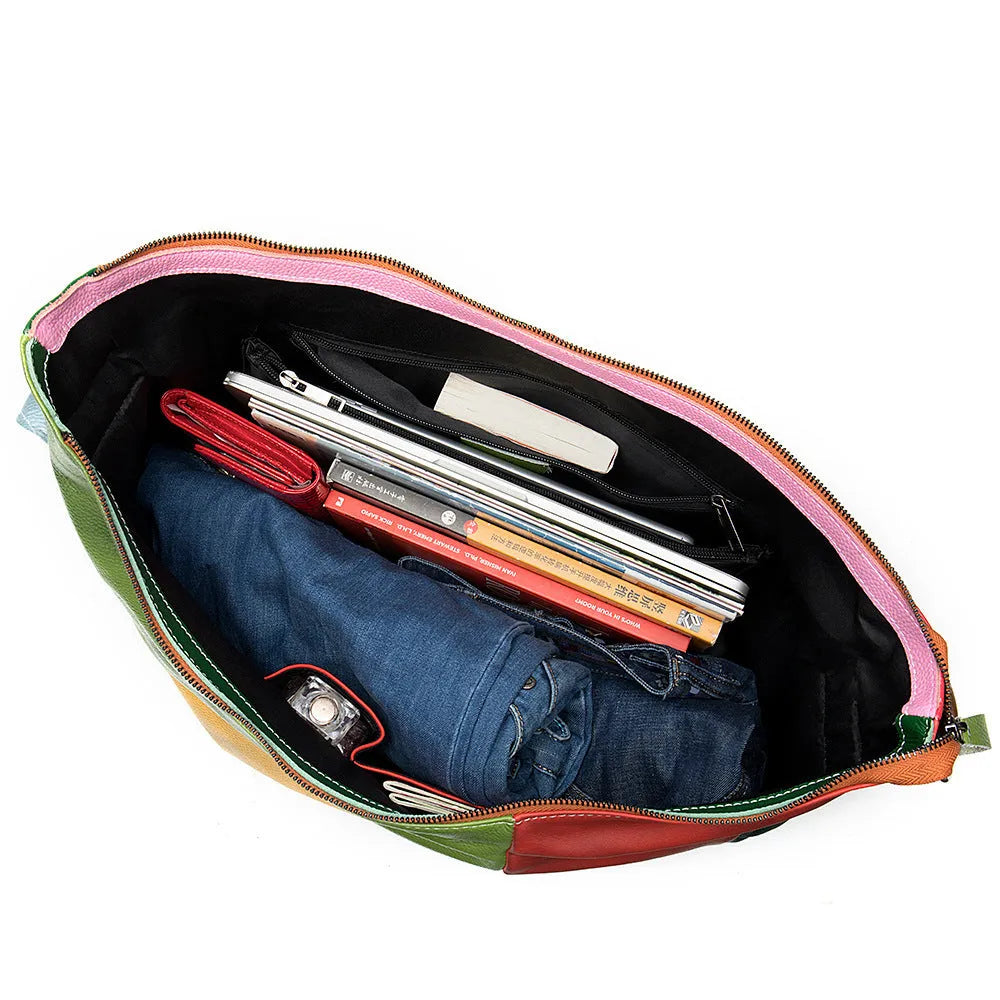 Cowhide leather crossbody travel bag showing stitching detail and capacity for 15-inch laptop