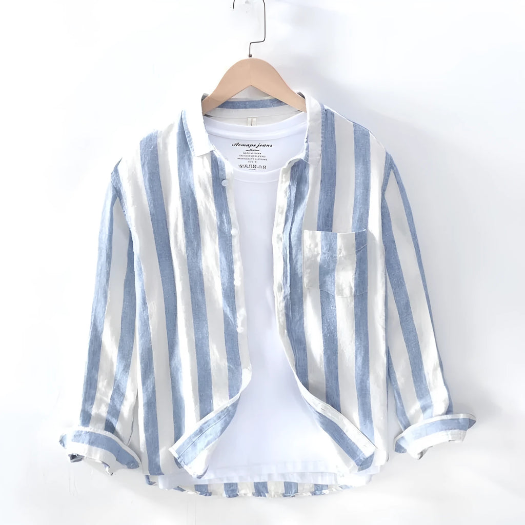 Men's blue loose-fit Hong Kong style long sleeve shirt on a hanger.