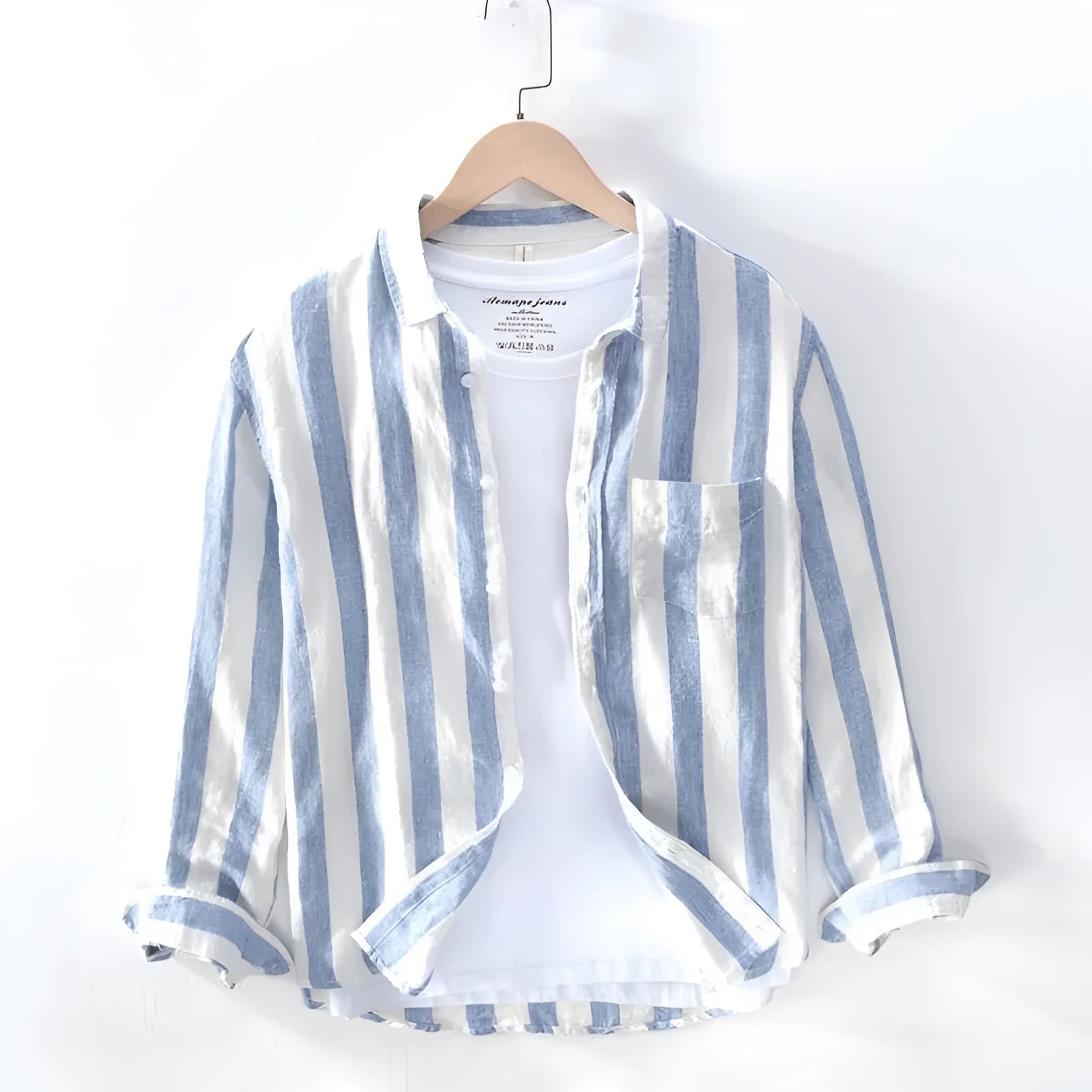 Men's blue loose-fit Hong Kong style long sleeve shirt on a hanger.