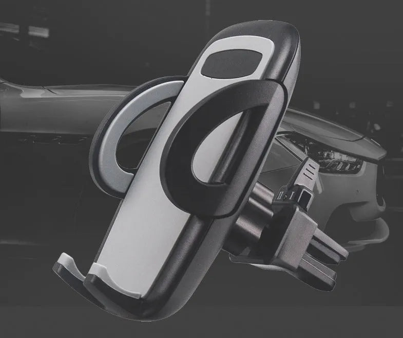 Black plastic car air vent phone holder mounted on car dashboard with mobile phone securely in cradle