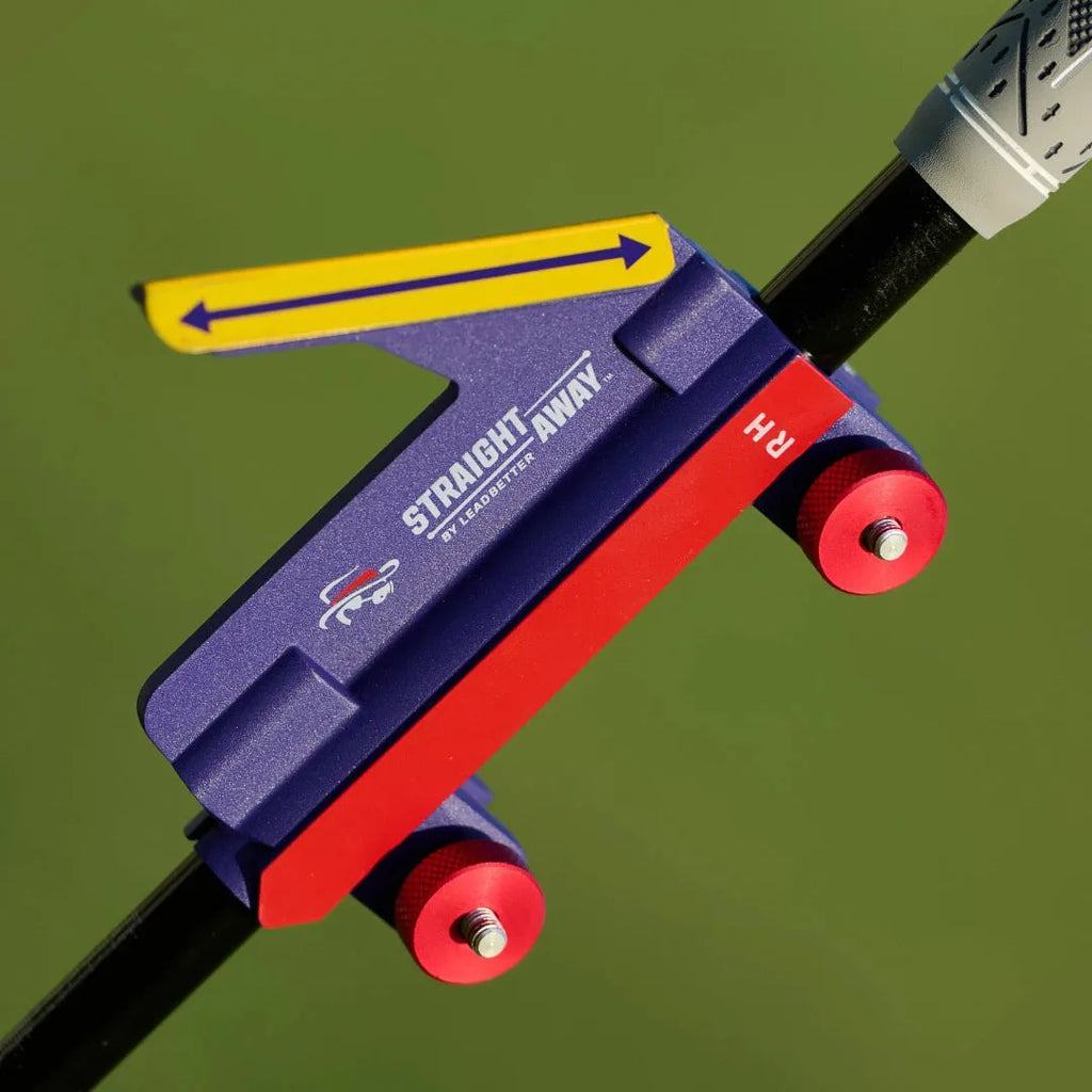 Plastic golf swing plane simulator training aid on practice surface