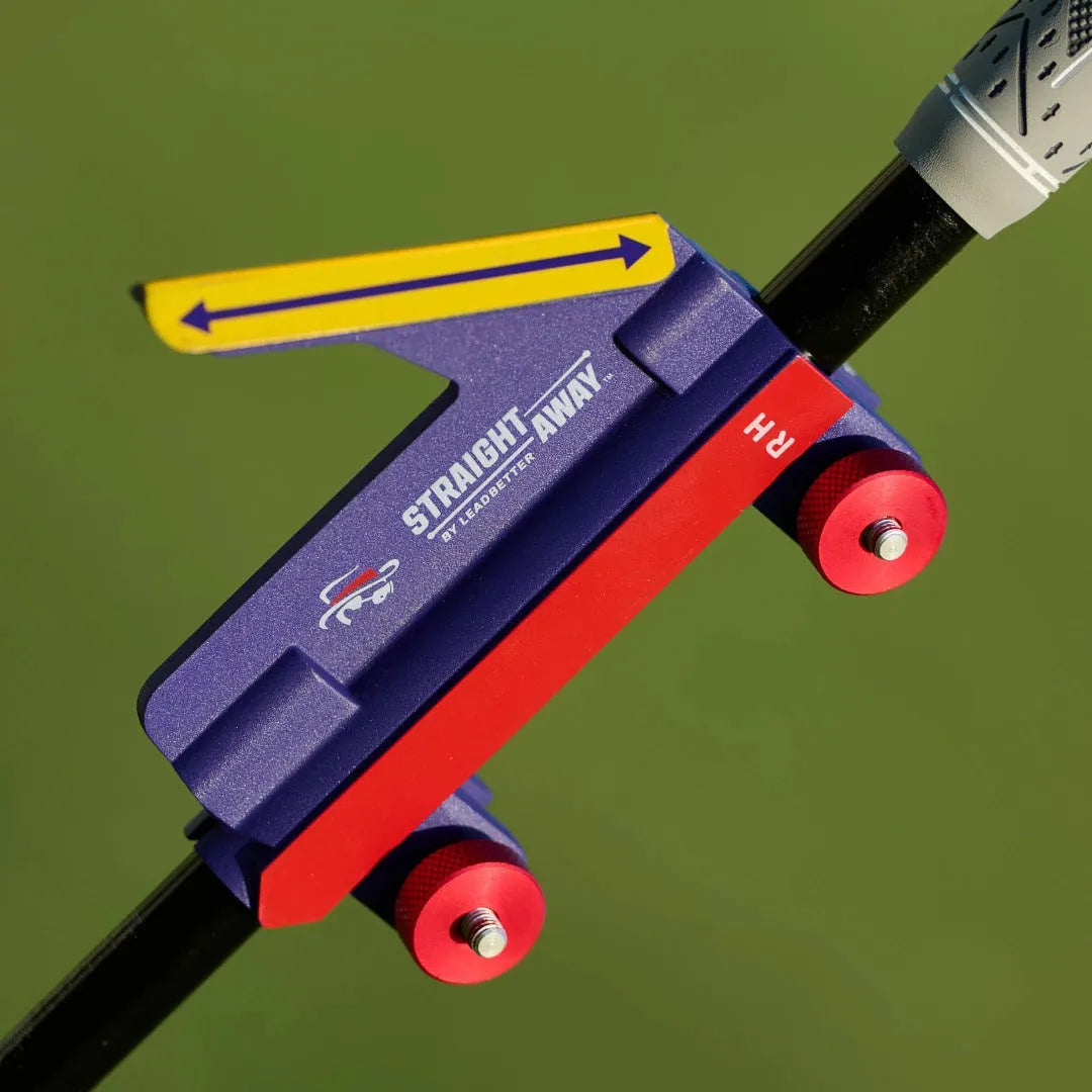 Plastic golf swing plane simulator training aid on practice surface