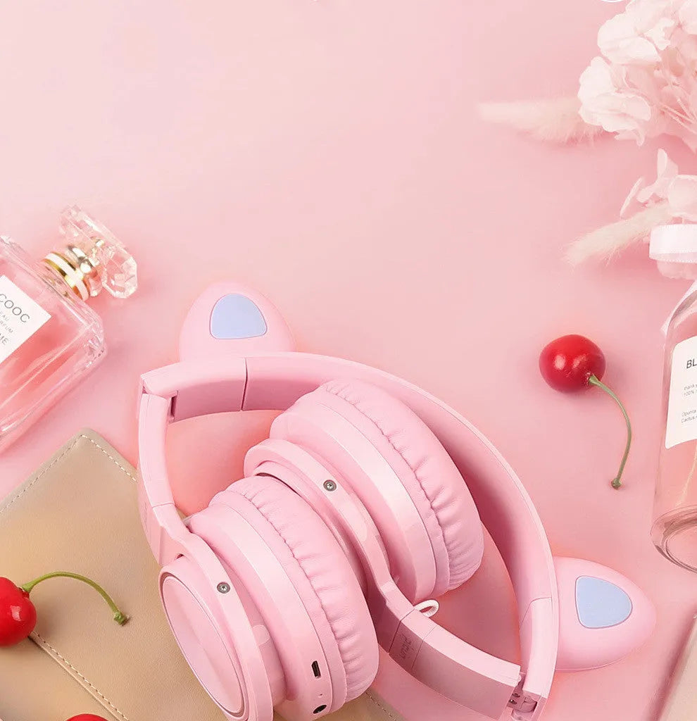 Pink white Bluetooth wireless over-ear headphones with braided cable and built-in microphone