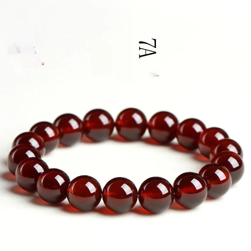 Natural orange red garnet ball bracelet with crystal beads showing ruyi pattern detailing