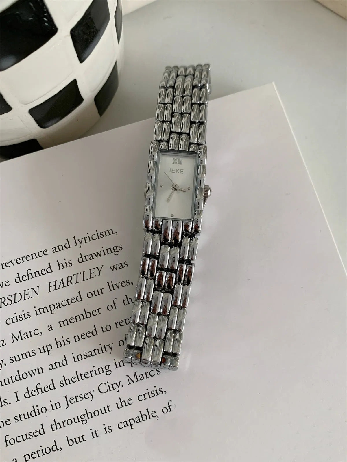 Women's vintage bracelet watch with a small dial, butterfly buckle, on a silver strap.