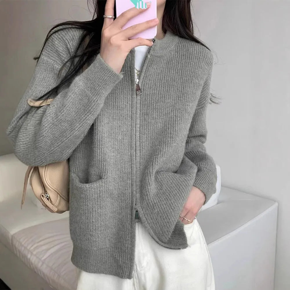 Beige viscose fibre soft wind cardigan coat with long sleeves on a hanger.