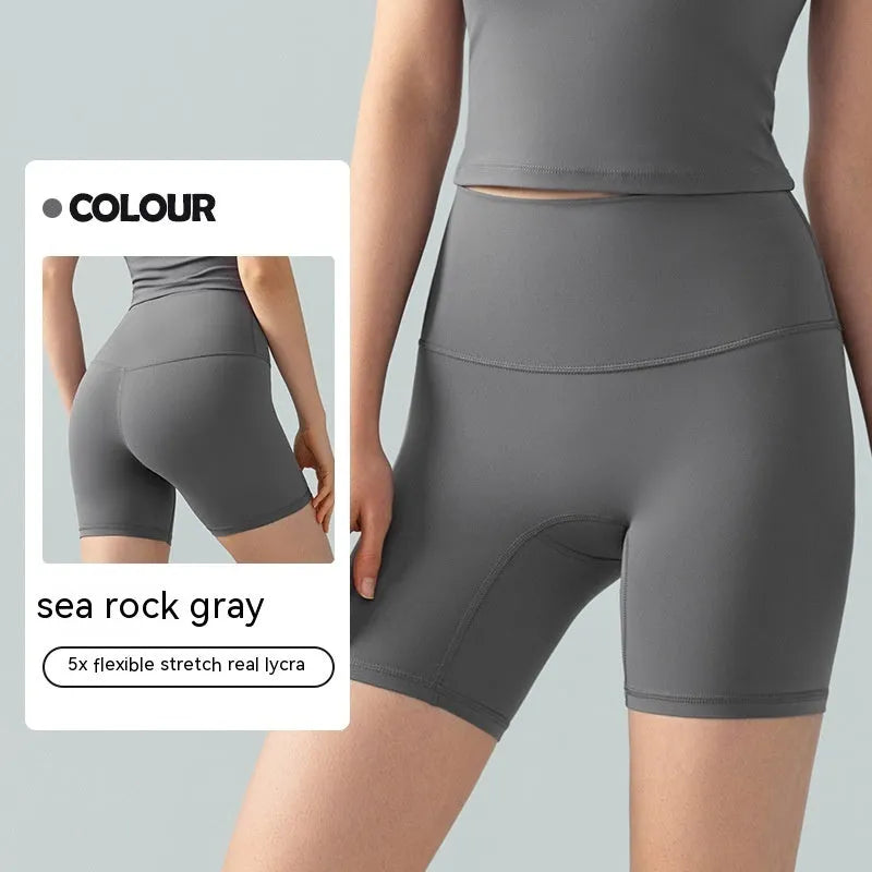 Women's high-waisted Lycra yoga shorts in leaf green, showing anti-exposure construction and short length.