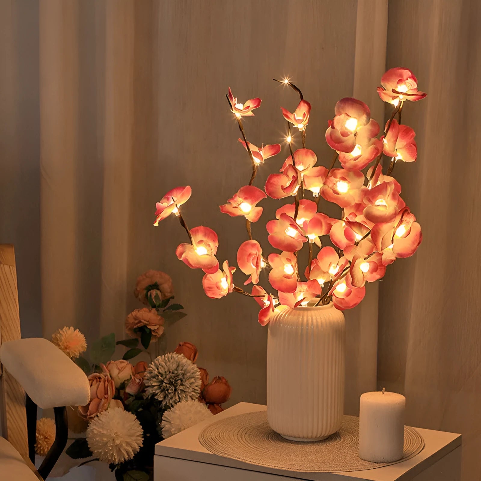 Pink Phalaenopsis orchid branch shaped LED decorative light on a table.