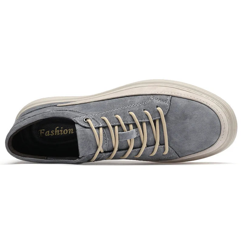 Men's grey low-top pigskin leather skate shoes with flat rubber sole and lace-up front.
