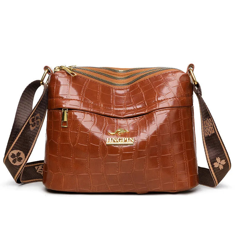 Large capacity multi compartment cross body bag in black with horizontal square shape and sewing thread detail