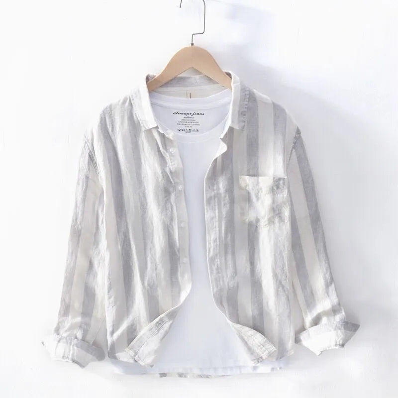 Men's blue loose-fit Hong Kong style long sleeve shirt on a hanger.