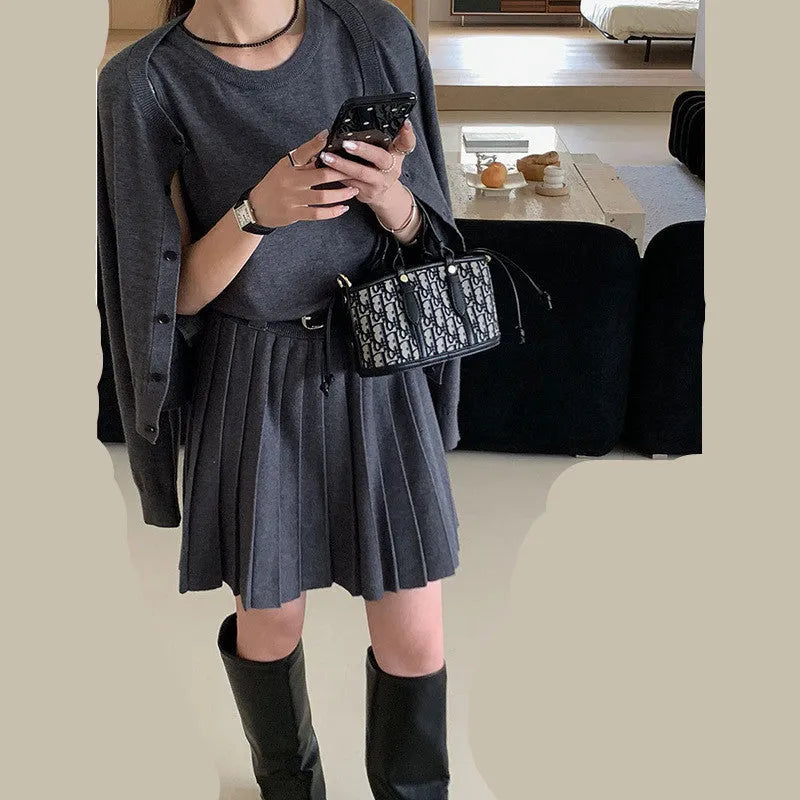 Women's grey knitted two-piece set with vest skirt, long-sleeved cardigan, belt, and 3D pattern detail