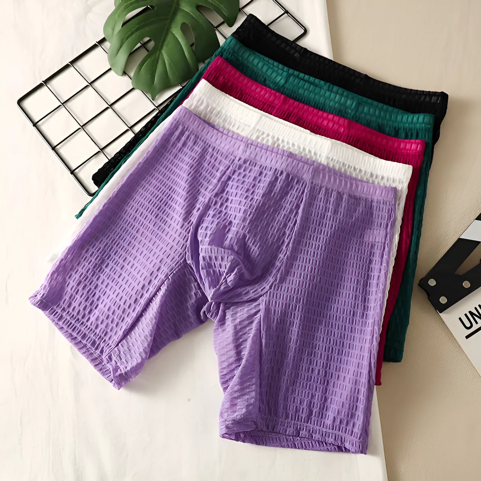 Men's solid colour lace boxer briefs for hip lifting and shaping, shown in light purple.