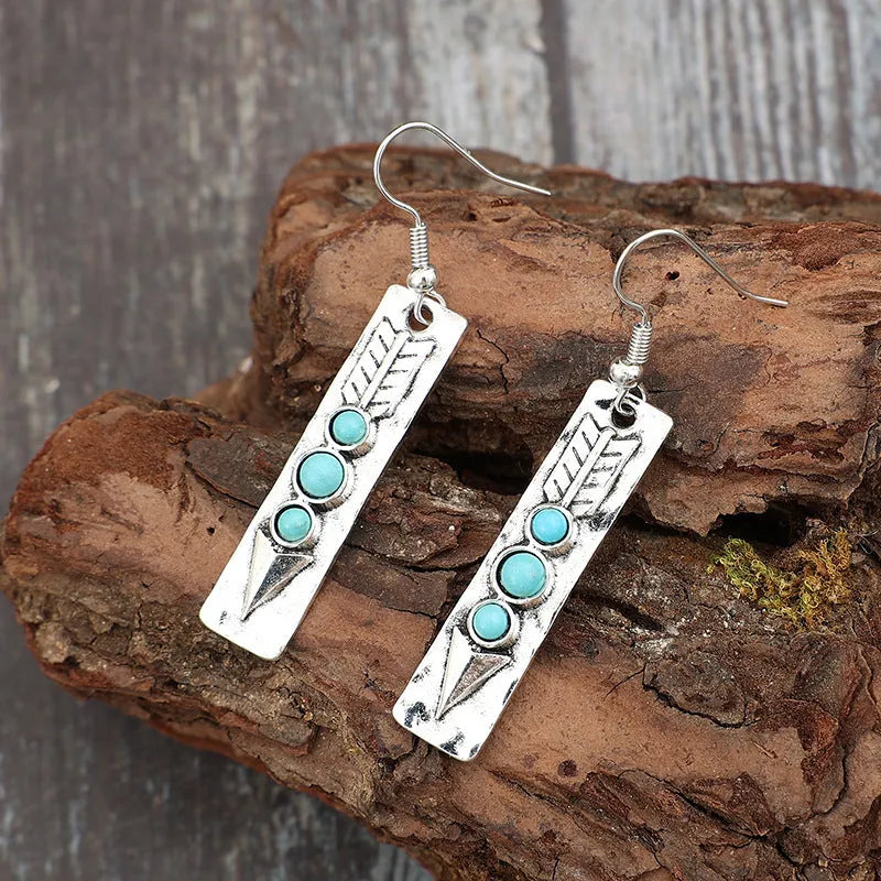 Silver geometric earrings with turquoise inlay on long strip zinc alloy design