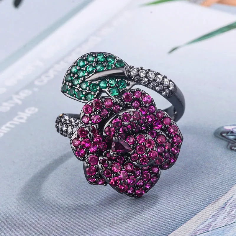 Black gold plated geometric floral ring with a red simulated corundum stone for women.