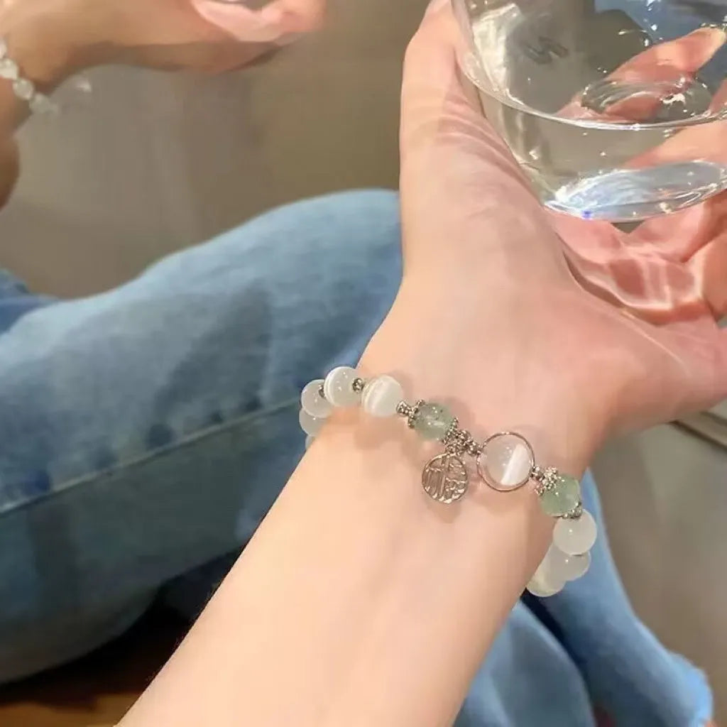 Women's glass butterfly drop-shape bracelet in a grey colourway with round details.
