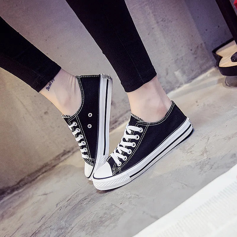 Solid colour canvas shoes for women on a plain background, showing the casual low-top design.