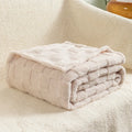 Geometric pattern polyester blanket in milky white colour showing thickened texture