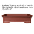 Large rectangular purple clay flowerpot with traditional handmade appearance and drainage holes