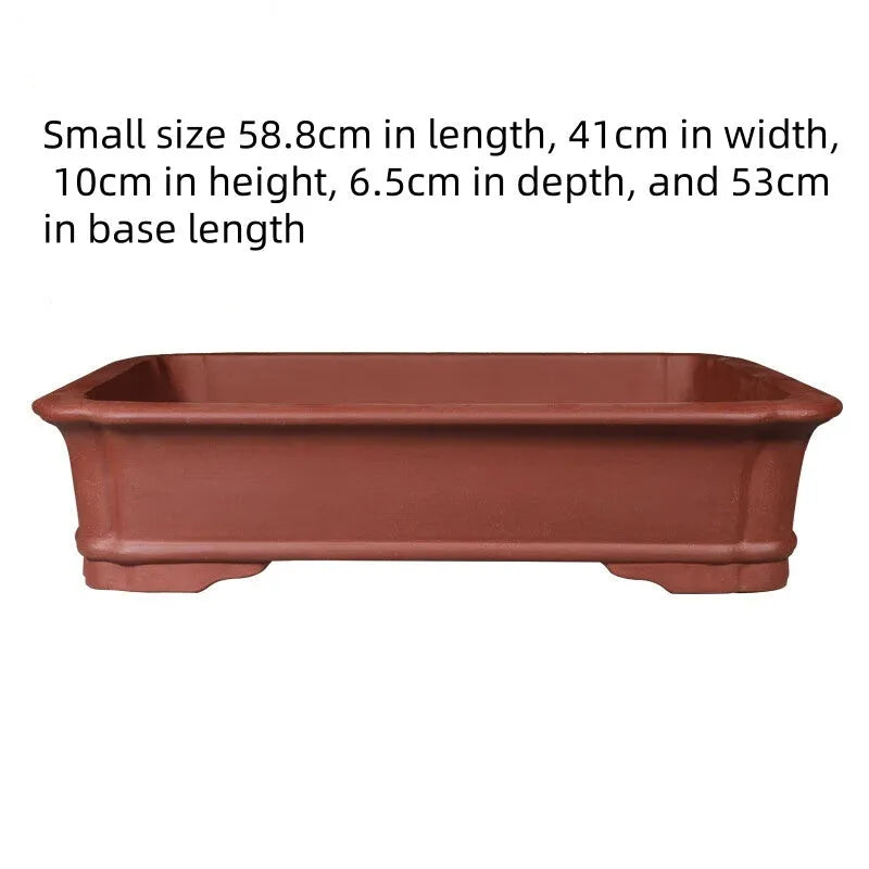 Large rectangular purple clay flowerpot with traditional handmade appearance and drainage holes