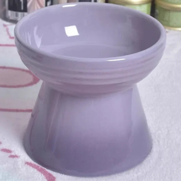A white ceramic pet bowl with a high foot and raised neck protector to prevent tipping.