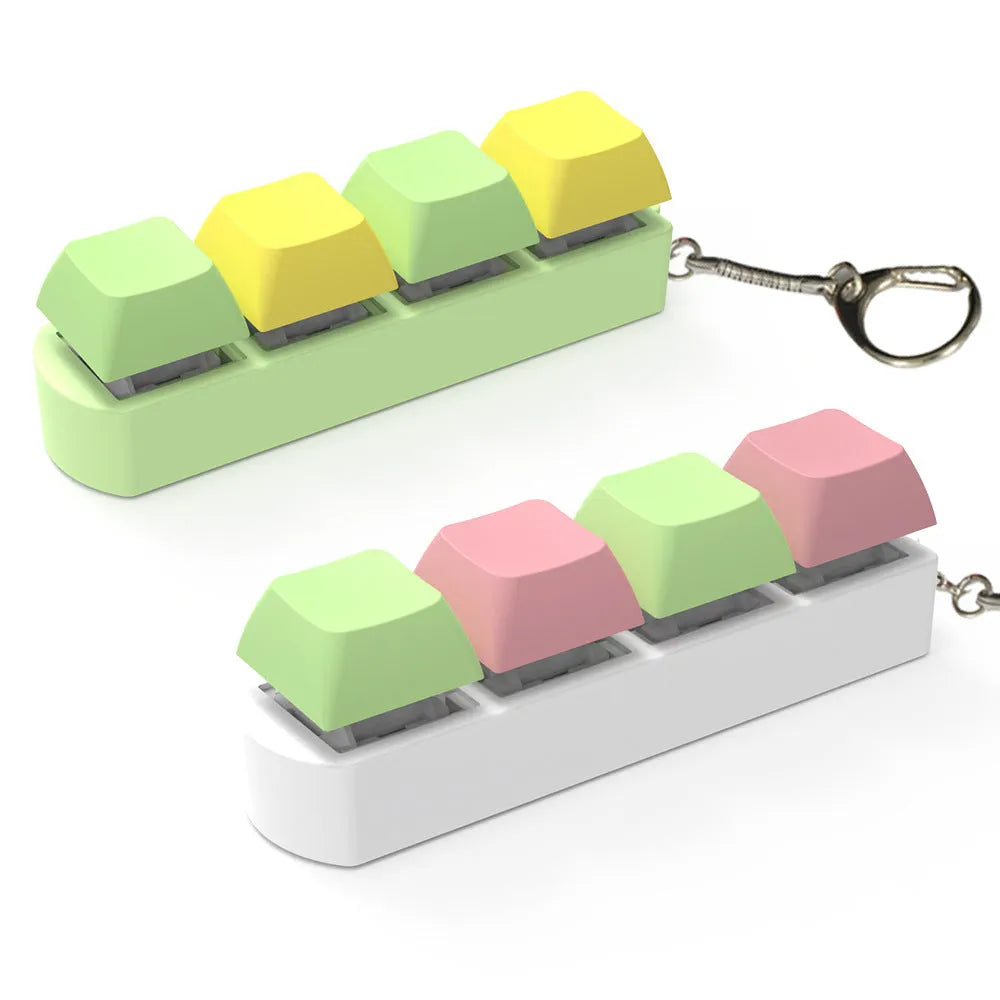 Four-key mechanical keyboard switch tester made of ABS plastic on a desk.