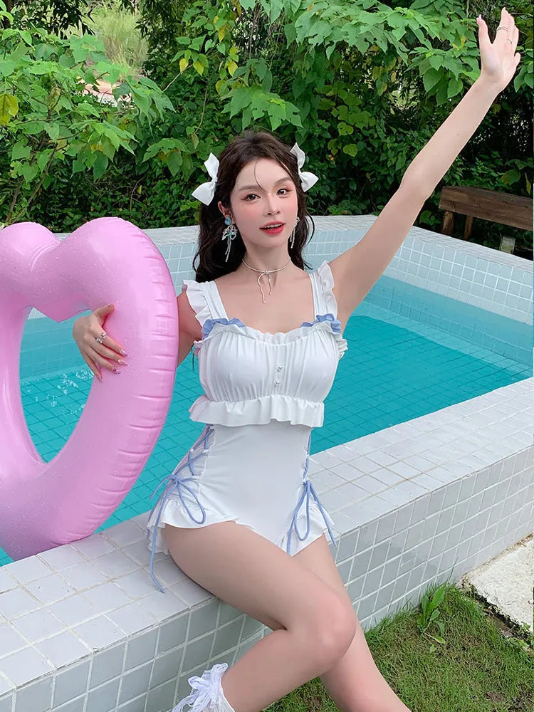 Milky White women's backless one-piece swimsuit made of nylon, shown on a model.