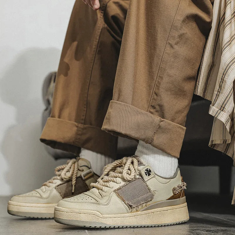 Beige low-top casual skate shoes with lace-up front and flat rubber sole.