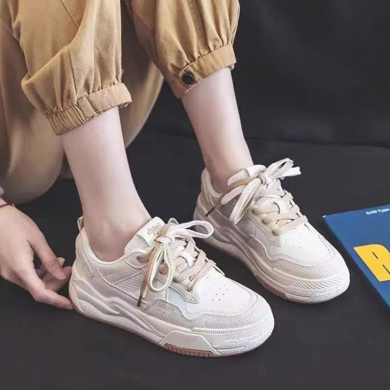 Beige and pink low-top platform sneakers with a rubber sole on a white background