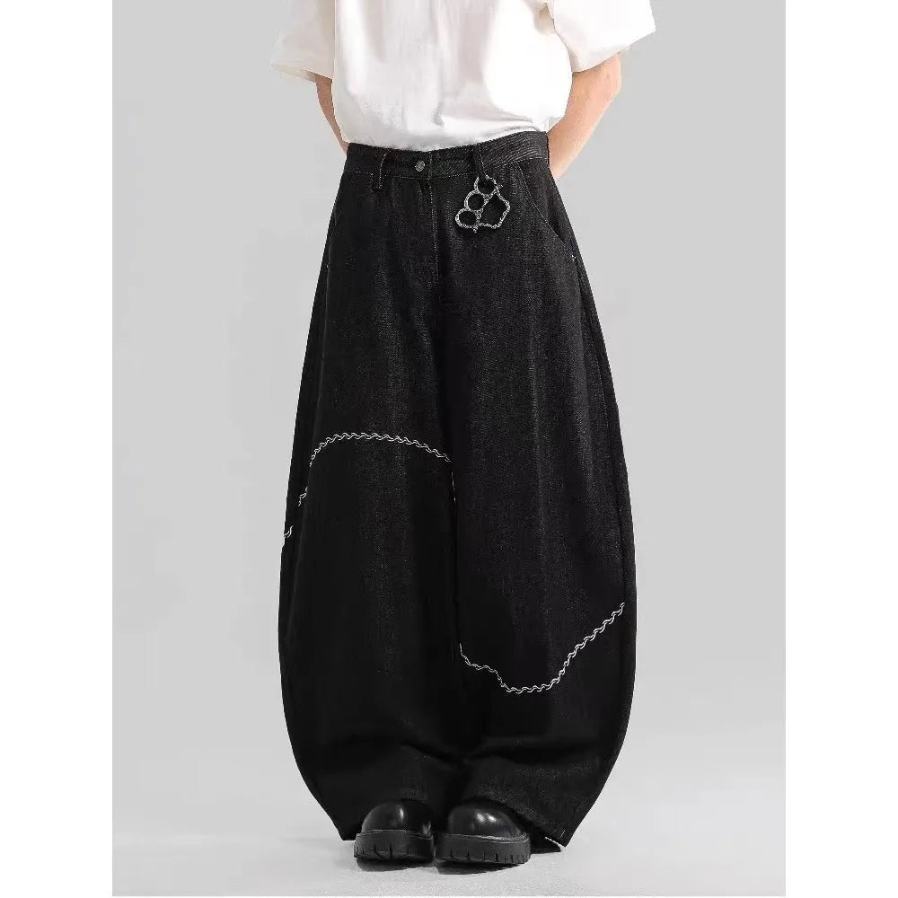 Black straight-leg denim trousers with a mid waist and zip fly, laid flat.