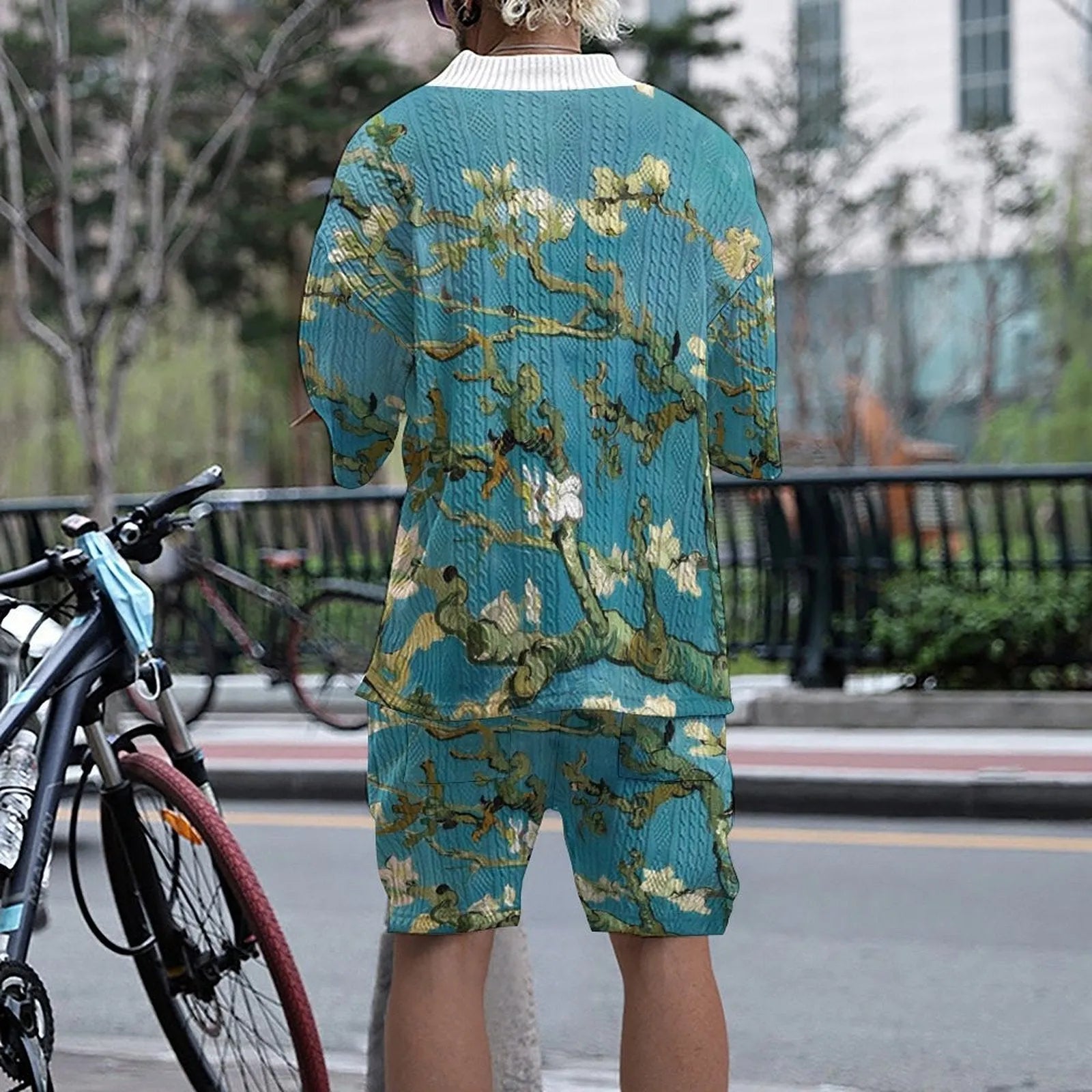 Men's peacock blue 3D printed knitted shorts and T-shirt casual suit set laid flat.