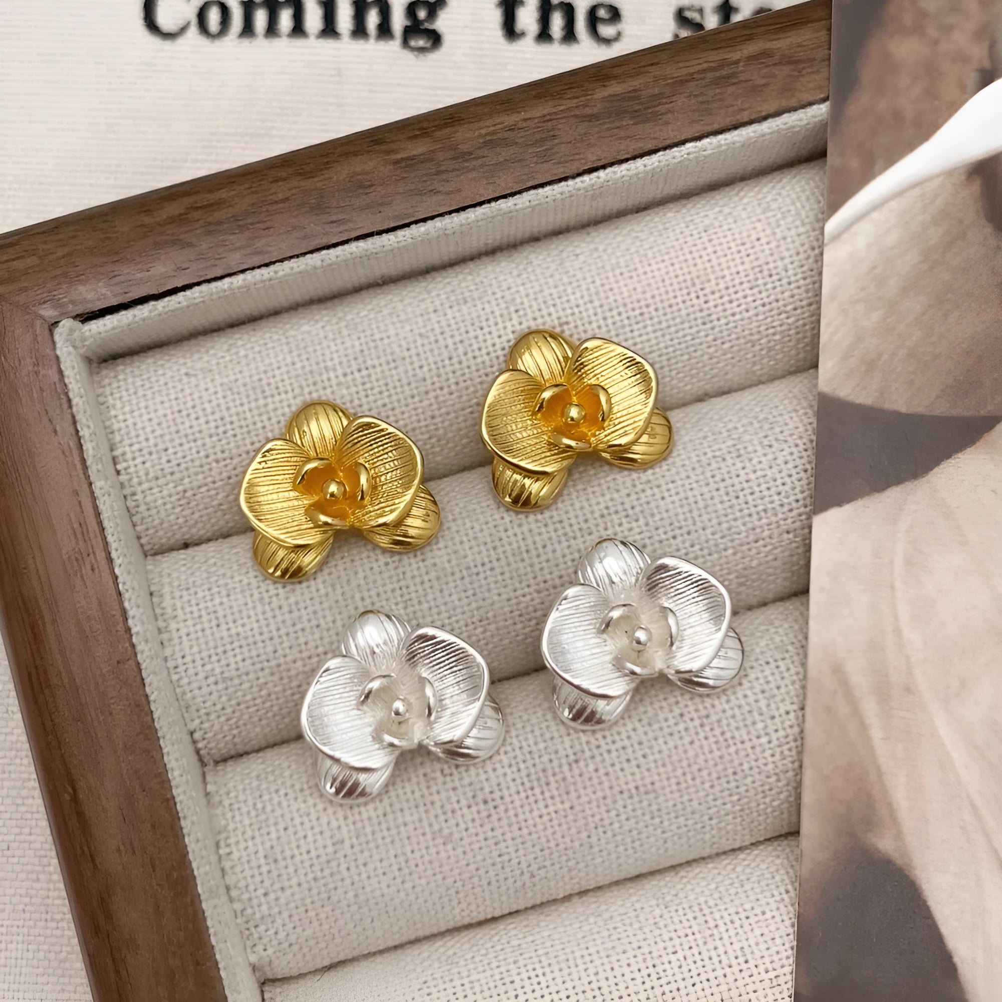 Retro floral fashion earrings in gold or silver colour with petal detailing on copper base.