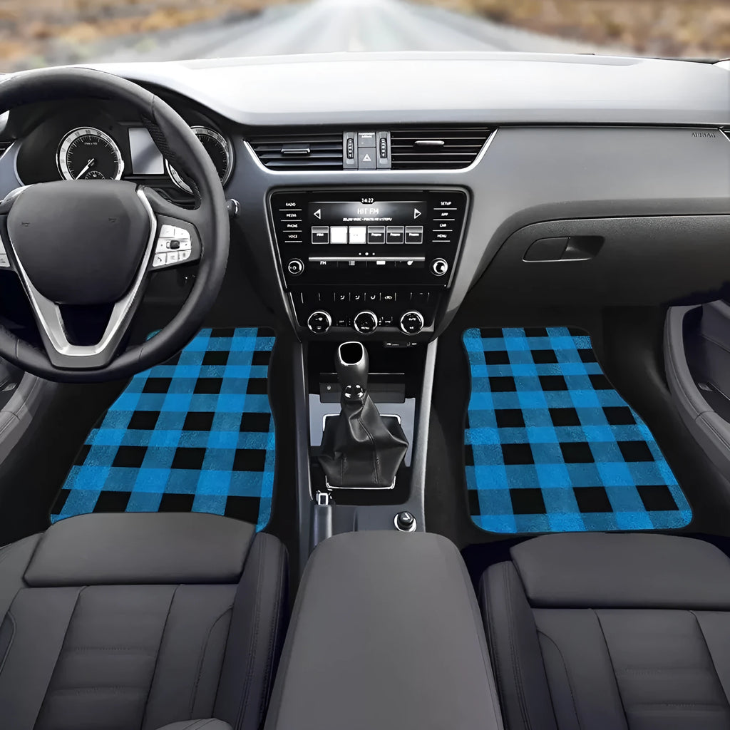Four-piece set of thick black rubber car floor mats with printed patterns laid out for a vehicle.