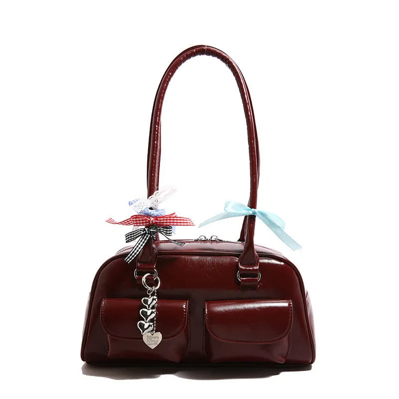 Brown PU leather retro pillow bag for women with a flap closure and double shoulder strap.