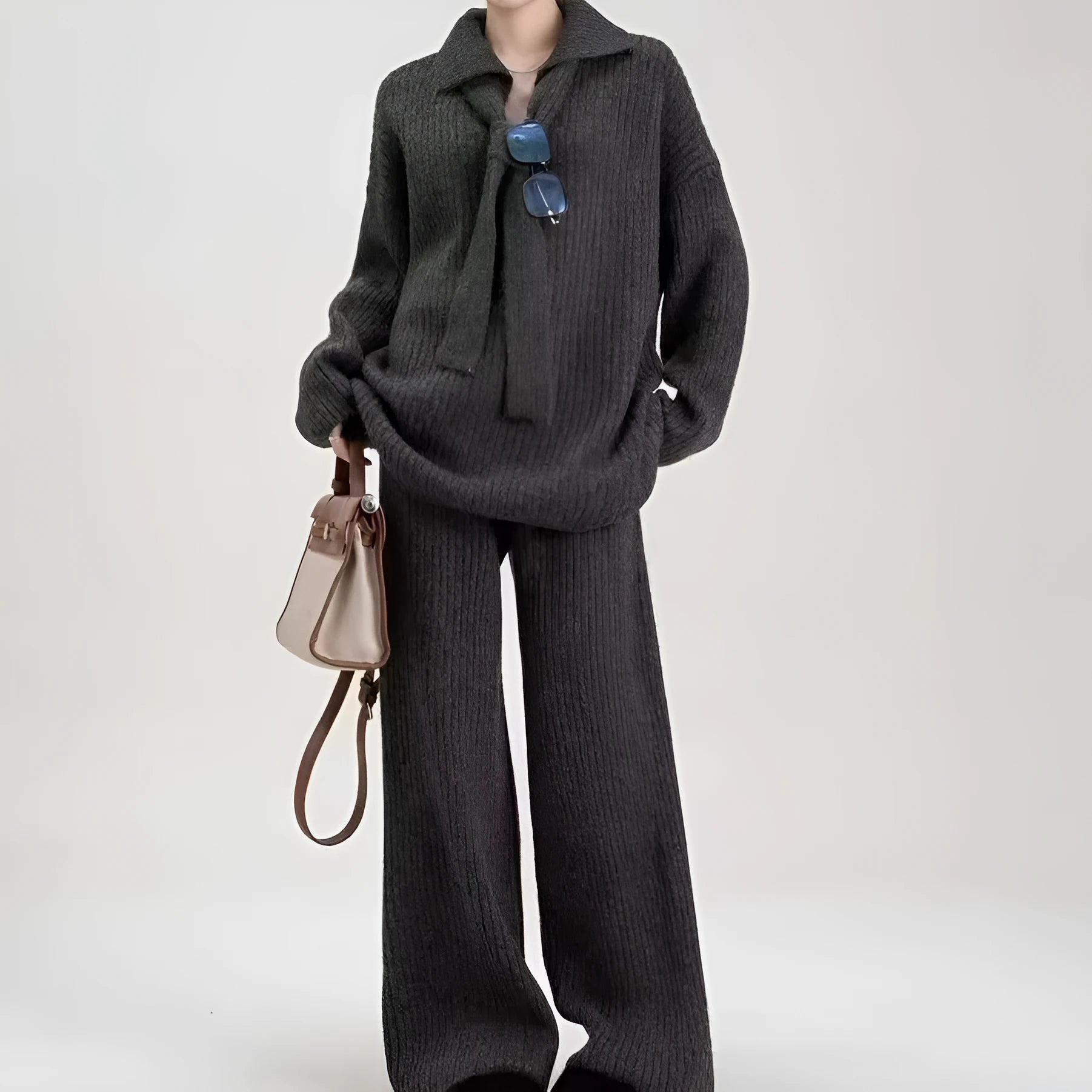 Beige imitation cashmere knitted top and matching trousers two-piece set laid flat.