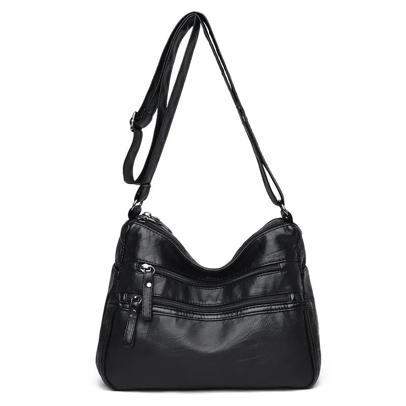 Women's washed leather crossbody bag in solid colour, retro messenger style with adjustable strap and soft handle