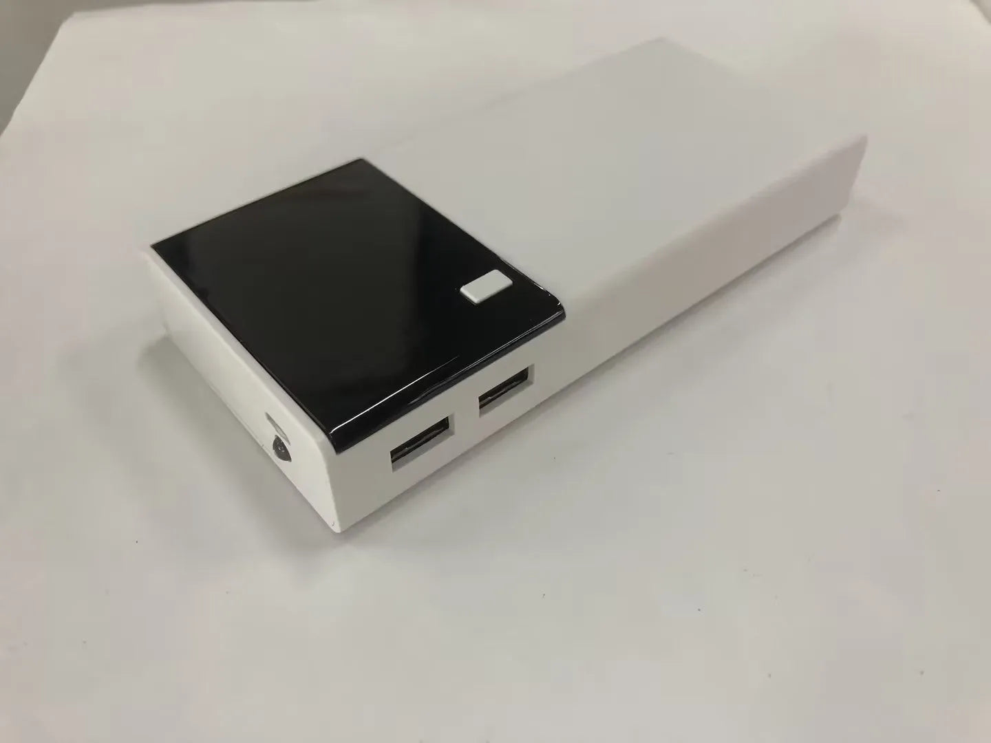 Black 20000mAh portable power bank with plastic shell showing dimensions of 135mm by 60mm