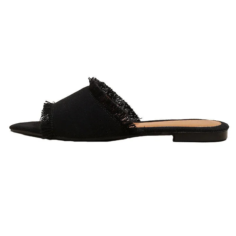 Women's denim flat slippers with a tassel, shown in available colours like apricot, black, and wine red.