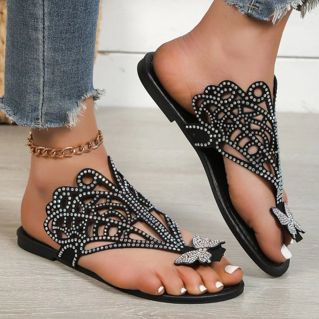 Women's black slip-on sandals with rhinestone details and a flip-toe design