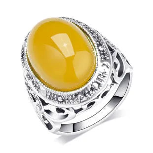 Close-up of a geometric retro ring in antique silver amber with a beeswax fluorescent finish.