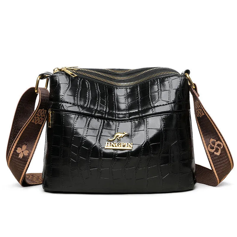 Large capacity multi compartment cross body bag in black with horizontal square shape and sewing thread detail