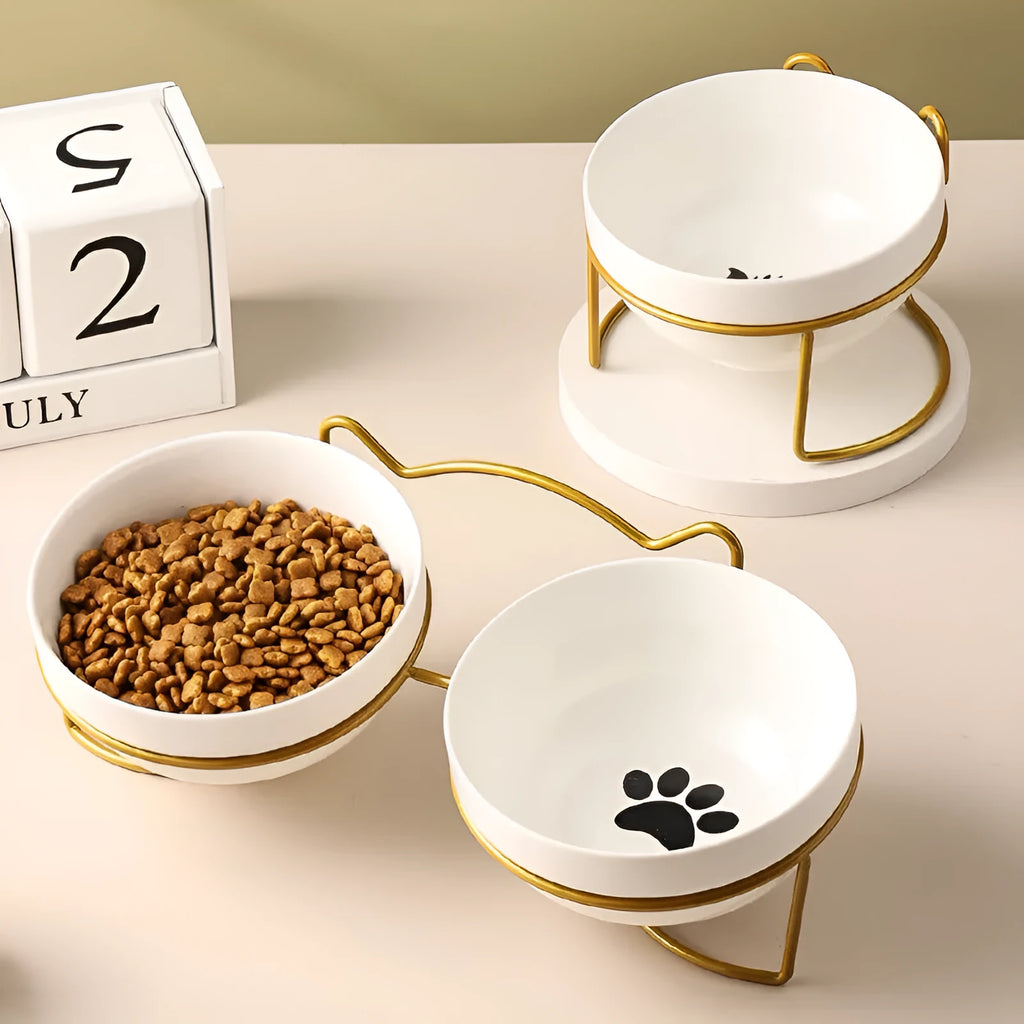 Ceramic cat bowl with iron frame stand showing cat paw print pattern and gold metal finish