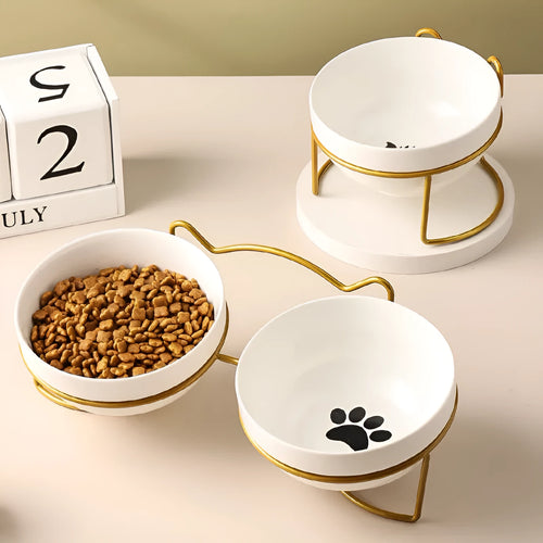 Ceramic cat bowl with iron frame stand showing cat paw print pattern and gold metal finish