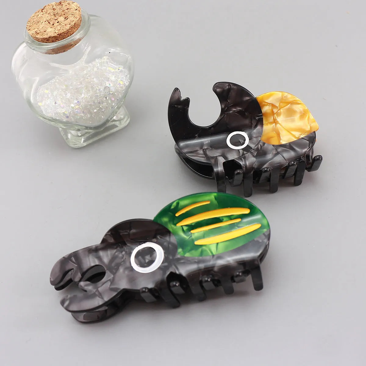 Cartoon-style beetle grip insect biology collectable on cellulose acetate sheet